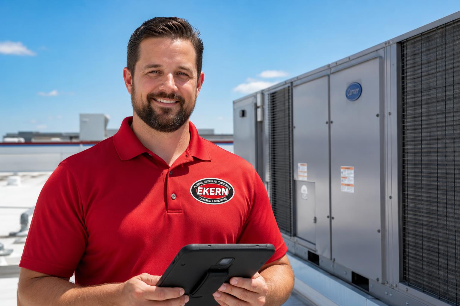 Ekern commercial HVAC technician on a rooftop next to packaged units